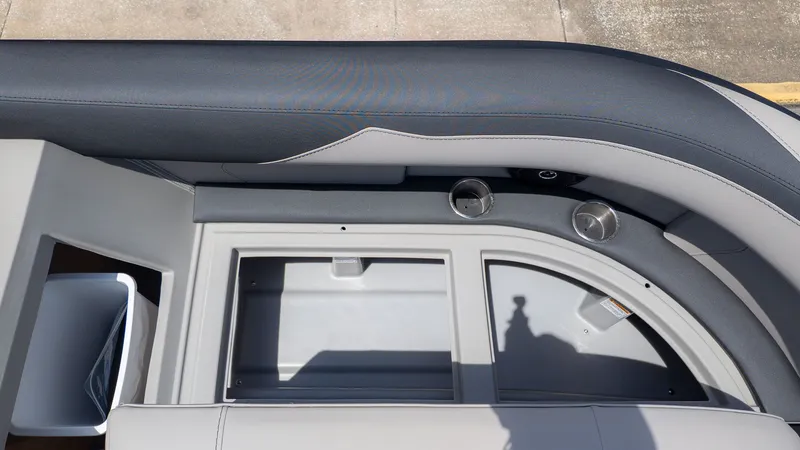 Slide: The Image of Close-up of a Barletta SANZA 22QC boat interior with gray upholstery and cup holders. - 19