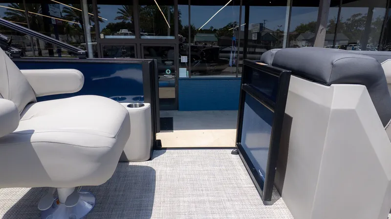 Slide: The Image of The image shows the interior of a Barletta SANZA 22QC boat with comfortable seating and a table. - 15