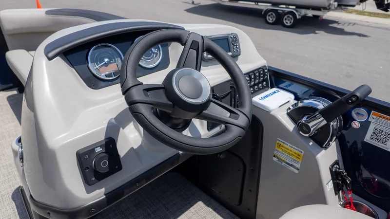 Slide: The Image of The image shows the helm of a Barletta SANZA 22QC boat with modern instruments. - 23