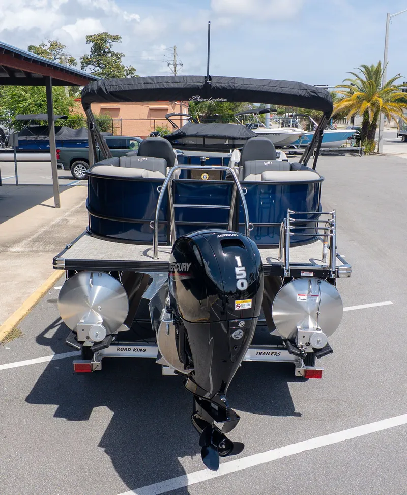 Slide: The Image of 2026 Barletta SANZA 22QC with Mercury 150 outboard motor, parked on a trailer. - 4