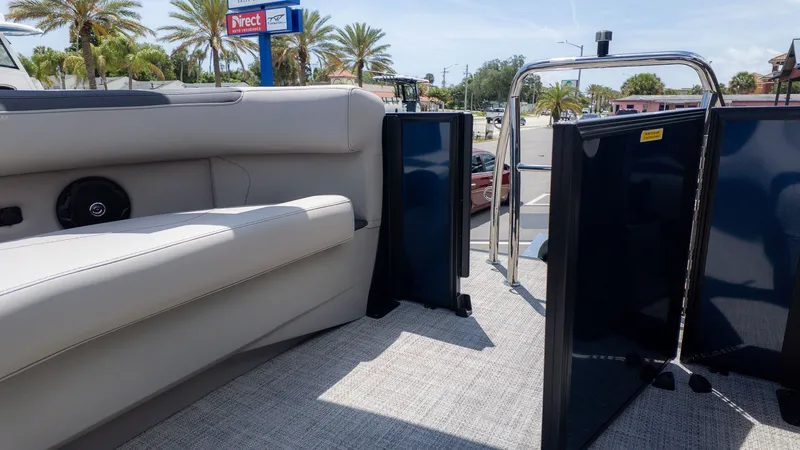 Slide: The Image of Interior of a 2026 Barletta SANZA 22QC with beige seating and blue doors. - 9