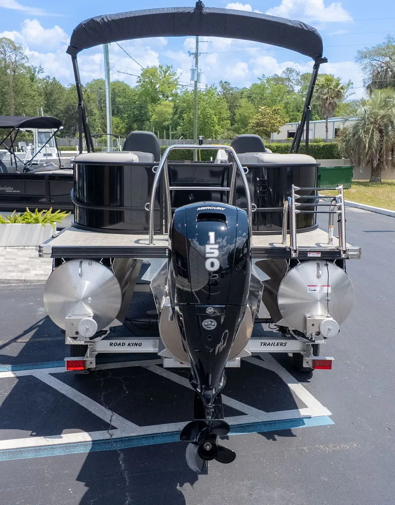 Slide: The Image of The image shows a Barletta SANZA 22QC pontoon boat on a trailer, with a 150 HP outboard motor. - 3