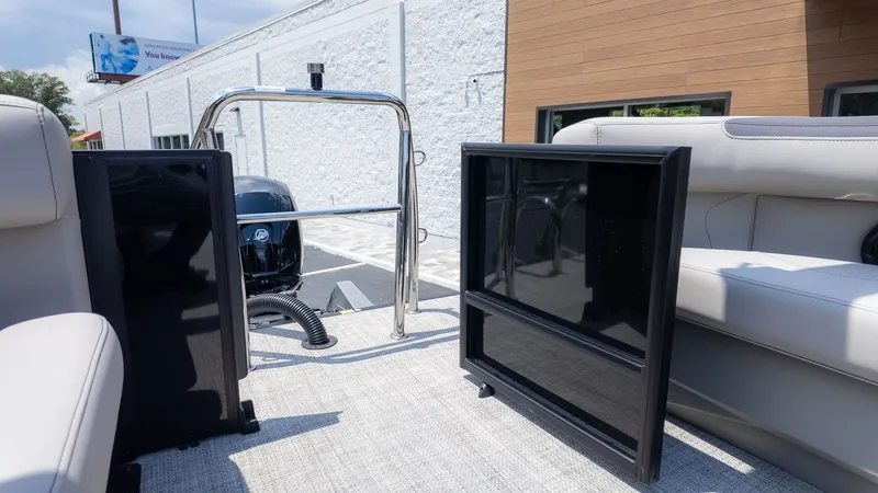 Slide: The Image of The image shows the rear of a Barletta SANZA 22QC boat with an outboard motor. - 3