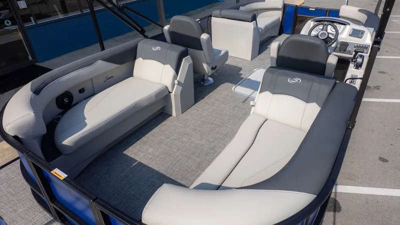 Slide: The Image of The image shows the interior of a Barletta Sanza S22QC boat with gray and white seating. - 5