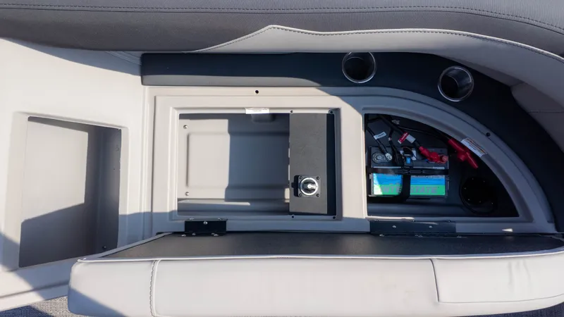 Slide: The Image of The image shows an open storage compartment with a battery and fuse box. - 7