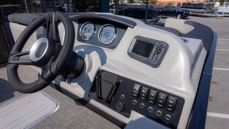 Slide: The Image of The image shows the helm of a Barletta Sanza S22QC boat with modern instruments. - 15