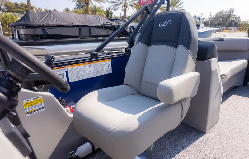 Slide: The Image of The 2026 Barletta Sanza S22QC features a comfortable captain's chair and modern helm. - 11