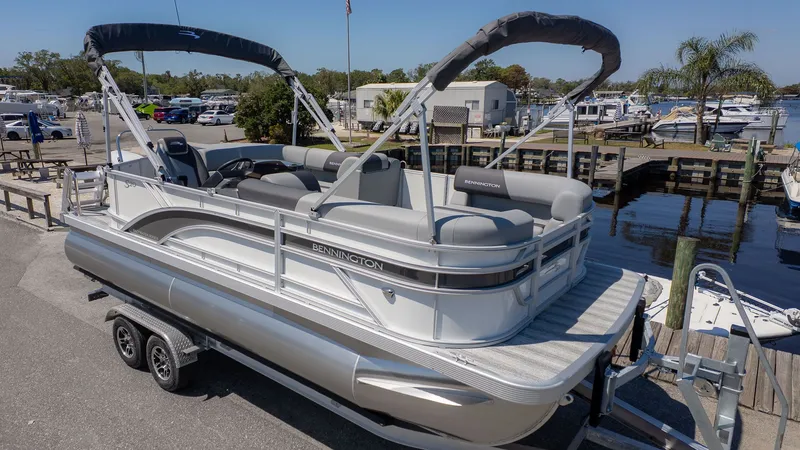 The Image of Bennington 20 S Cruise pontoon boat at dock with gray seating and sunshade. - 1