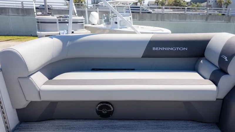 Slide: The Image of The image shows a gray seating area on a Bennington boat. - 12