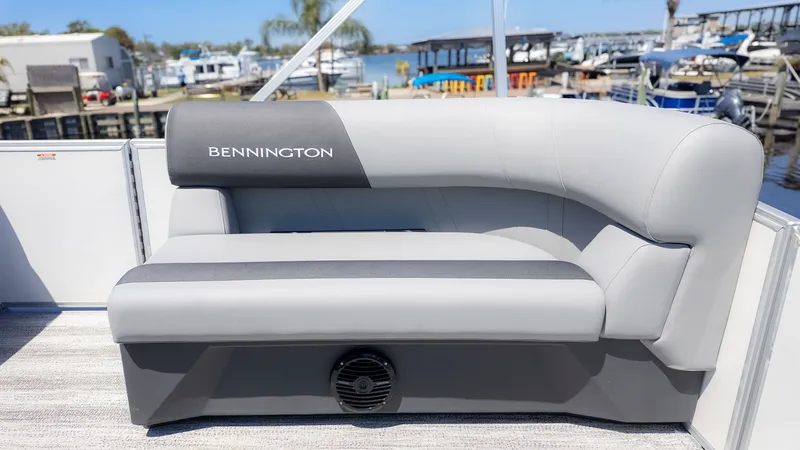 Slide: The Image of The image shows a gray bench seat on a boat with "Bennington" branding. Boats and a marina are visible in the background. - 9