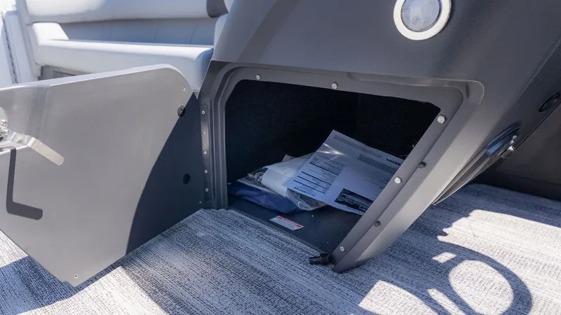 Slide: The Image of An open storage compartment on a boat with documents and accessories. - 14