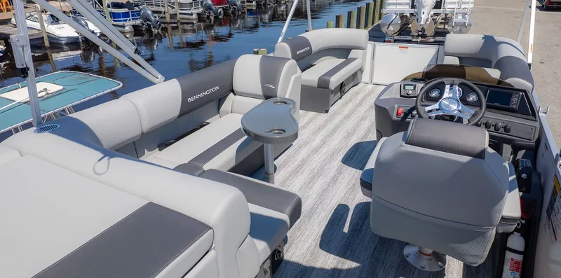 Slide: The Image of The image shows the interior of a Bennington 20 S Cruise boat with gray seating and a helm. - 3