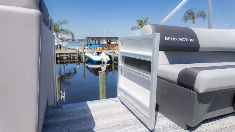 Slide: The Image of Bennington 20 S Cruise 2026: Sleek pontoon boat by calm water with palm trees in the background. - 7