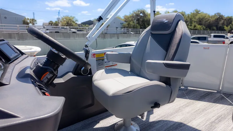 Slide: The Image of The helm of a 2026 Bennington 20 S Cruise with a cushioned captain's chair. - 14