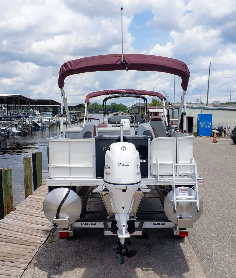 Slide: The Image of A Bennington 21 S Fish and Cruise pontoon boat at the dock with an outboard motor. - 3