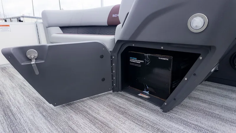 Slide: The Image of An open storage compartment on a Bennington 21 S Fish and Cruise boat. - 15
