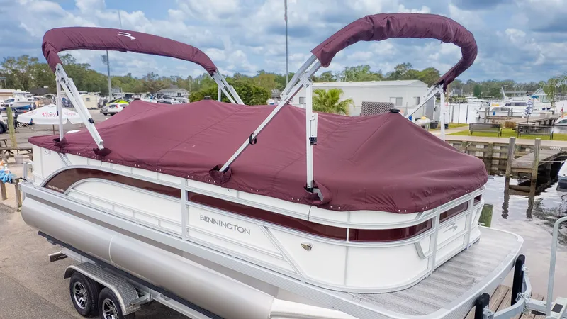 The Image of 2026 Bennington 21 S Fish and Cruise with maroon canopy, on a trailer. - 1