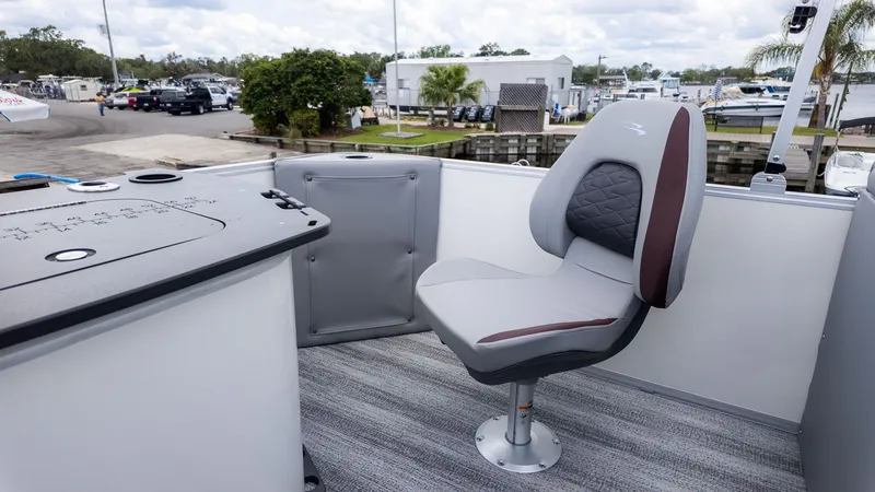 Slide: The Image of A modern seat on a boat with gray upholstery and armrests. - 4