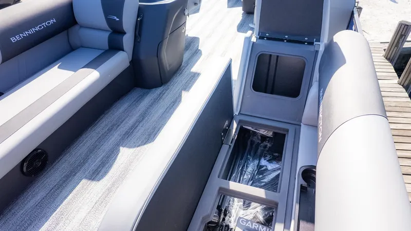 Slide: The Image of Interior of a Bennington 21 S CRUISE boat with gray seating and storage compartments. - 10