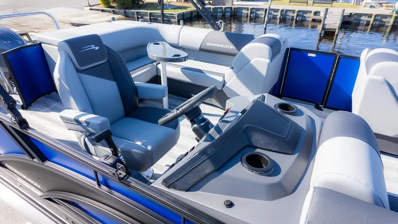 Slide: The Image of The image shows the cockpit of a Bennington 21 S CRUISE pontoon boat with luxurious seating and controls. - 14