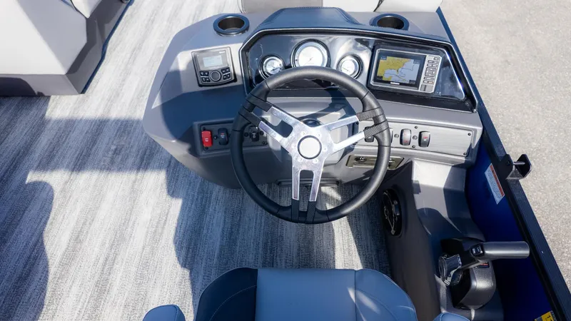 Slide: The Image of The image shows the helm of a Bennington 21 S CRUISE boat with modern instruments. - 16