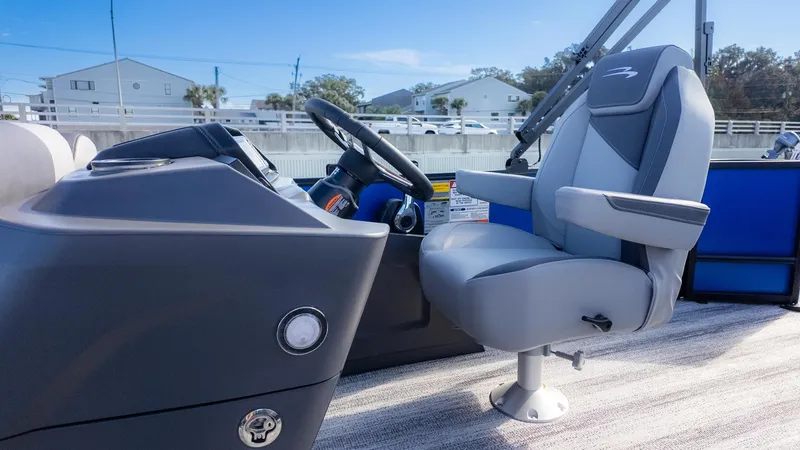 Slide: The Image of The image shows the helm of a Bennington 21 S CRUISE boat with a gray captain's chair. - 15