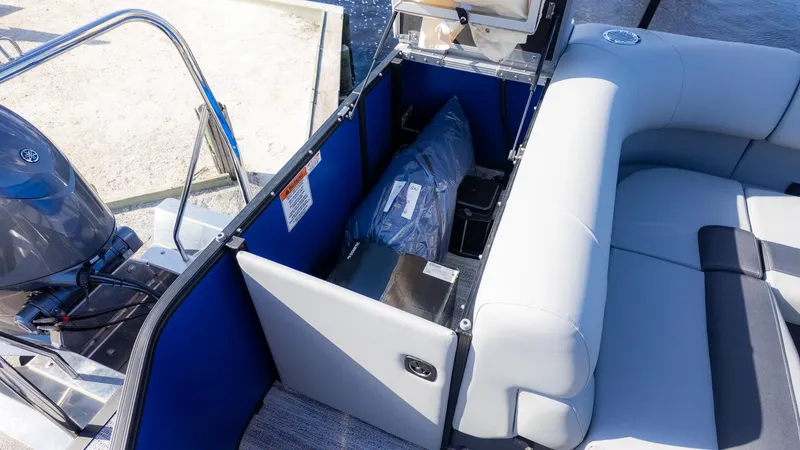 Slide: The Image of Interior view of a Bennington 21 S CRUISE boat with gray seating and storage area. - 19