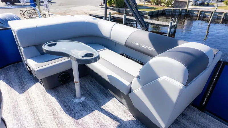 Slide: The Image of The image shows a gray seating area on a boat with a small table. - 6