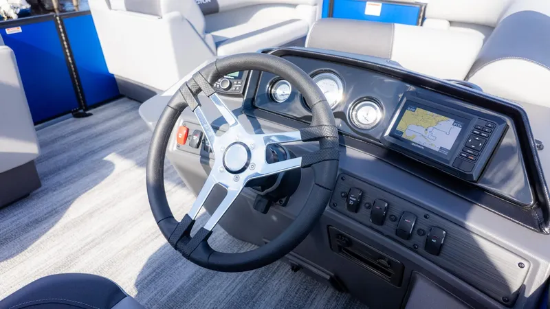 Slide: The Image of The image shows the helm of a 2026 Bennington 21 S CRUISE boat with a steering wheel and instruments. - 16