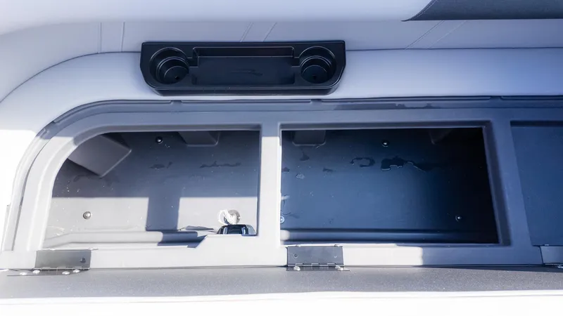 Slide: The Image of Interior view of a boat with cup holders and storage compartments. - 11