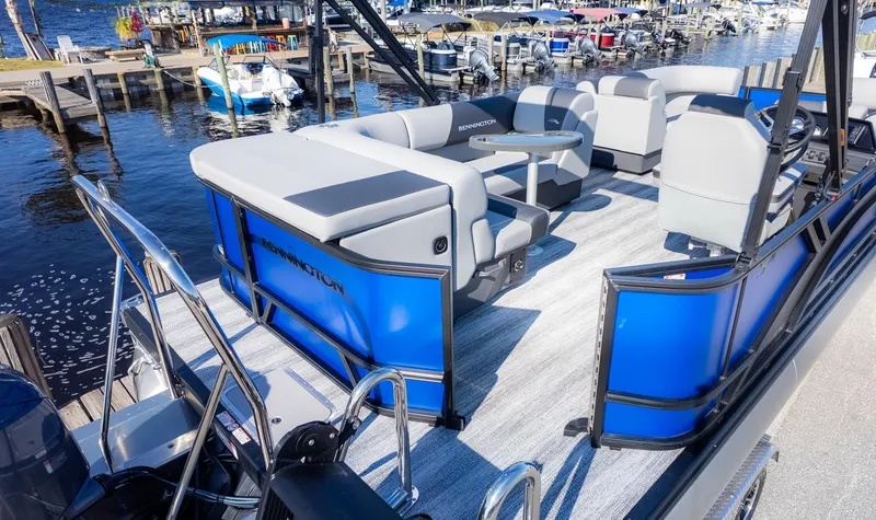 Slide: The Image of The image shows a Bennington 21 S CRUISE pontoon boat with blue sides and gray seating. - 4