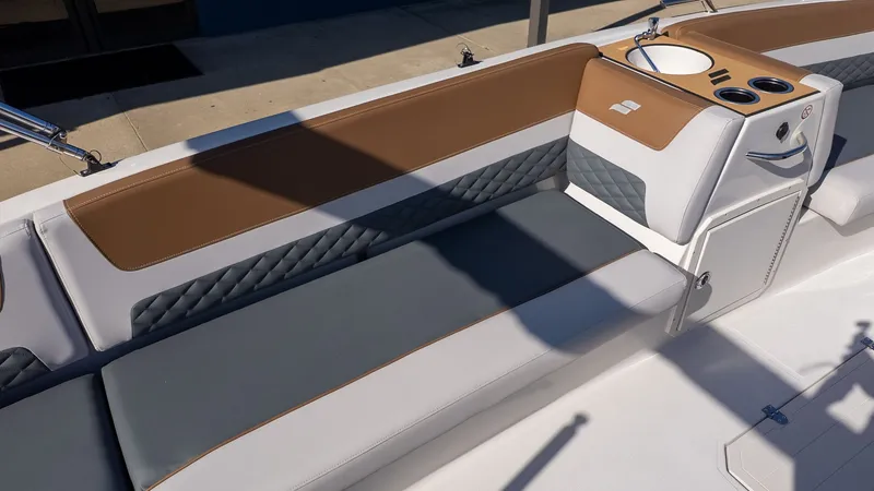 Slide: The Image of The image shows the seating area of a Starcraft SVX 211 OB boat with brown and gray upholstery. - 11