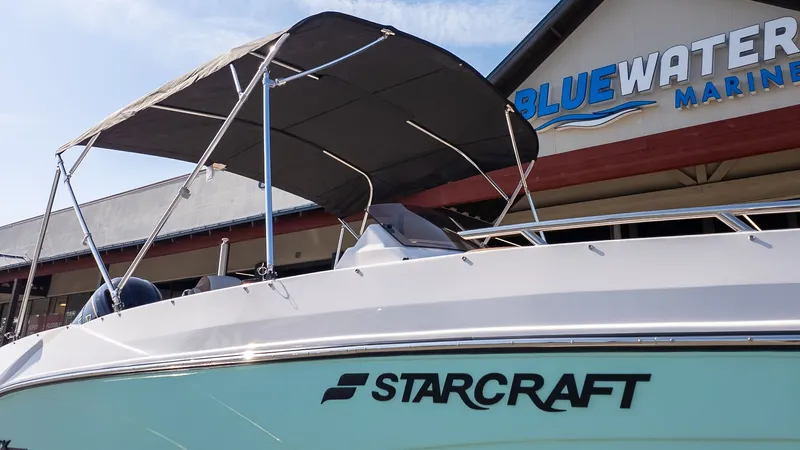 Slide: The Image of The image shows a Starcraft SVX 211 OB boat with a black sunshade. - 23