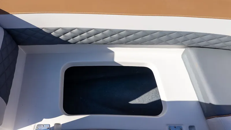 Slide: The Image of Interior of a Starcraft SVX 211 OB with cushioned seating and storage area. - 14