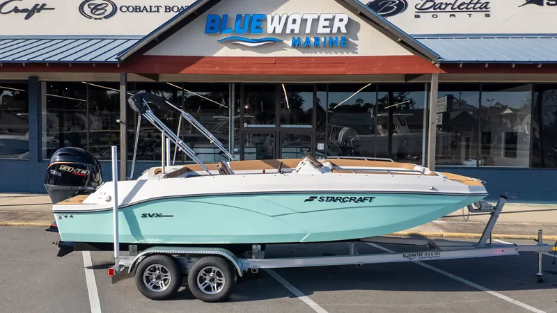 Slide: The Image of A Starcraft SVX 211 OB boat on a trailer in front of a marine store. - 22