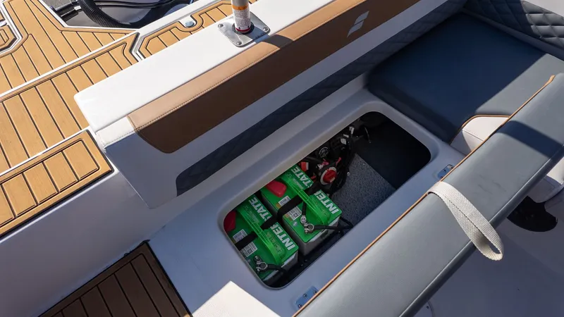 Slide: The Image of The image shows the storage compartment of a Starcraft SVX 211 OB boat with beverages. - 9