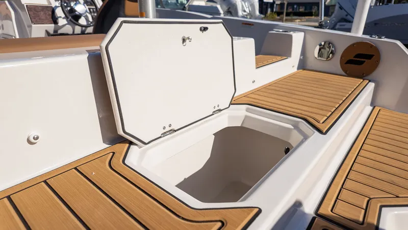 Slide: The Image of The image shows the interior of a Starcraft SVX 211 OB boat with an open storage compartment. - 6