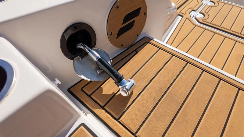 Slide: The Image of Close-up of a boat deck with wood-like finish and a fuel filler cap. - 4