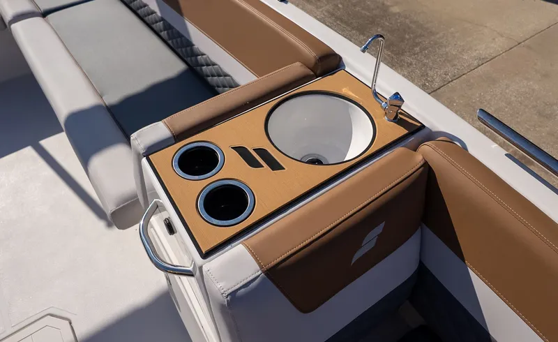 Slide: The Image of The image shows a boat console with a sink and cup holders. - 12