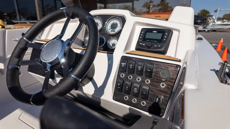 Slide: The Image of The image shows the helm of a Starcraft SVX 211 OB boat with modern instruments. - 20