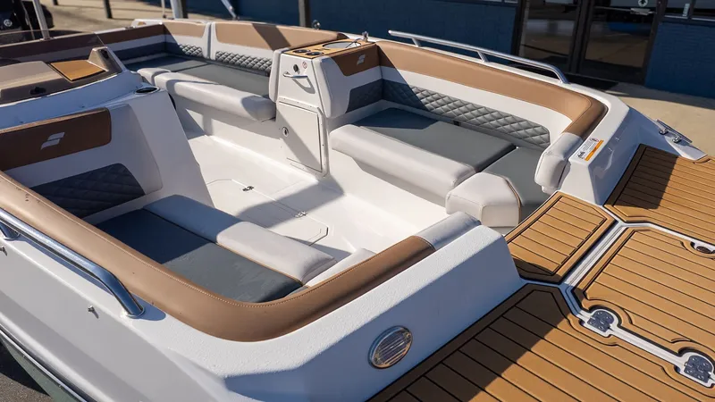 Slide: The Image of The image shows the interior of a Starcraft SVX 211 OB boat with sleek seating and wood flooring. - 14