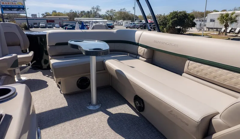 Slide: The Image of Interior of a Bennington 21 S Fishing boat with beige seating and a small table. - 11
