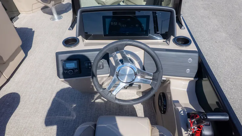 Slide: The Image of The image shows the helm of a 2026 Bennington 21 S Fishing boat with modern instruments. - 18