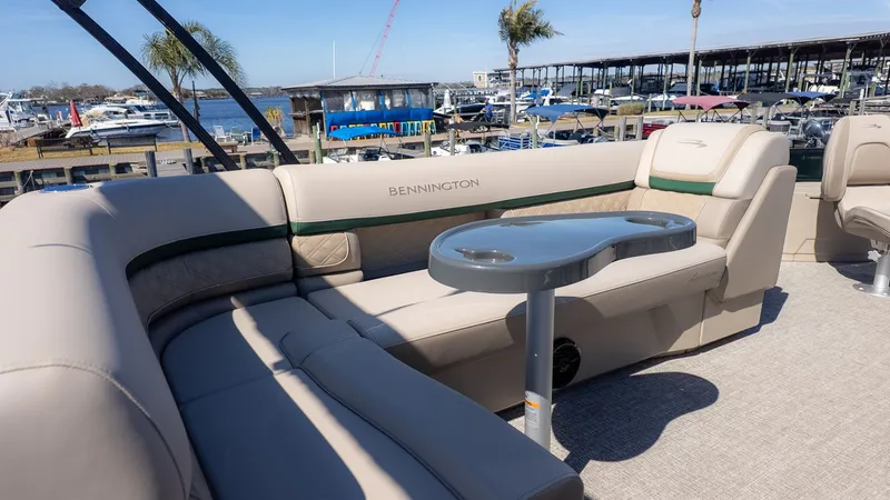 Slide: The Image of Bennington 21 S Fishing 2026: Spacious seating area with table, perfect for relaxing by the water. - 6