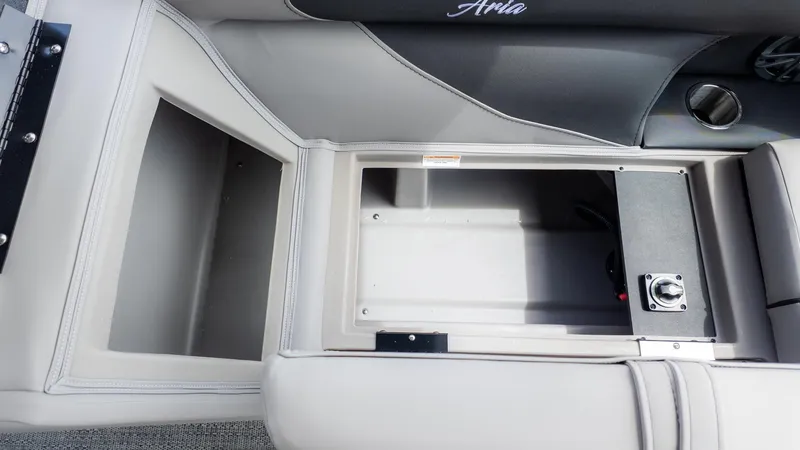 Slide: The Image of Interior view of a boat with gray upholstery and an open storage compartment. - 8