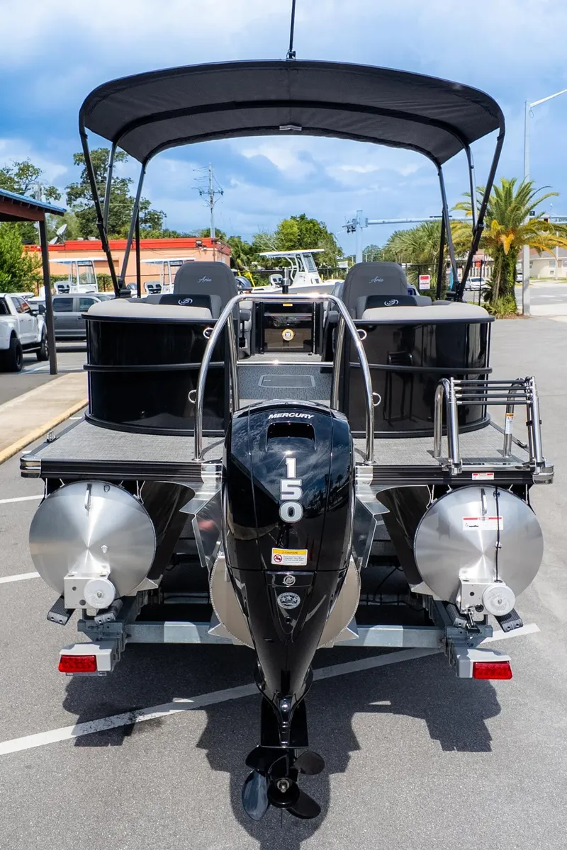 Slide: The Image of The image shows a Barletta ARIA 22QC pontoon boat with a 150 HP engine, parked in a lot. - 6