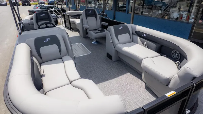 Slide: The Image of The image shows the interior of a Barletta ARIA 22QC pontoon boat with gray seating. - 12