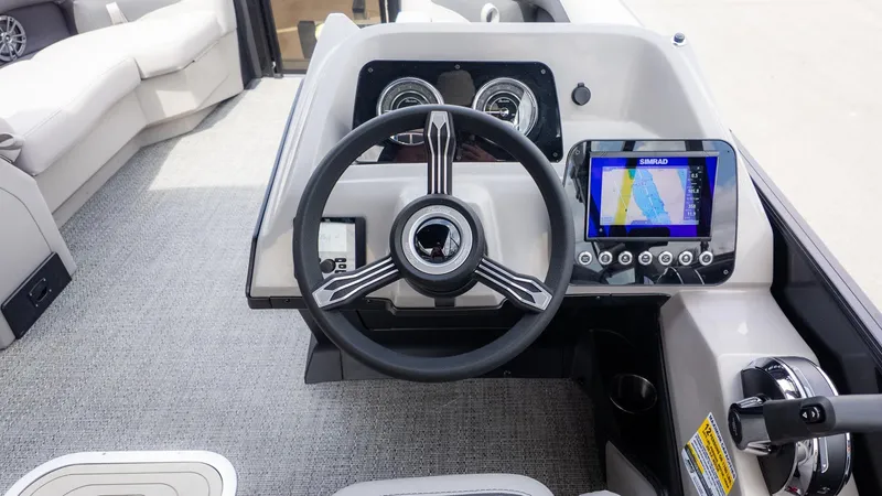 Slide: The Image of The image shows the helm of a Barletta ARIA 22QC boat with modern instruments. - 17