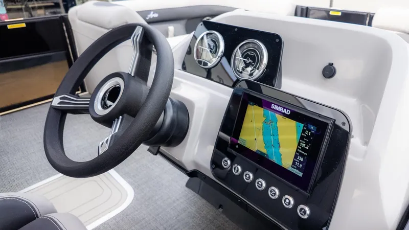 Slide: The Image of The image shows the helm of a Barletta ARIA 22QC with a modern navigation system. - 19