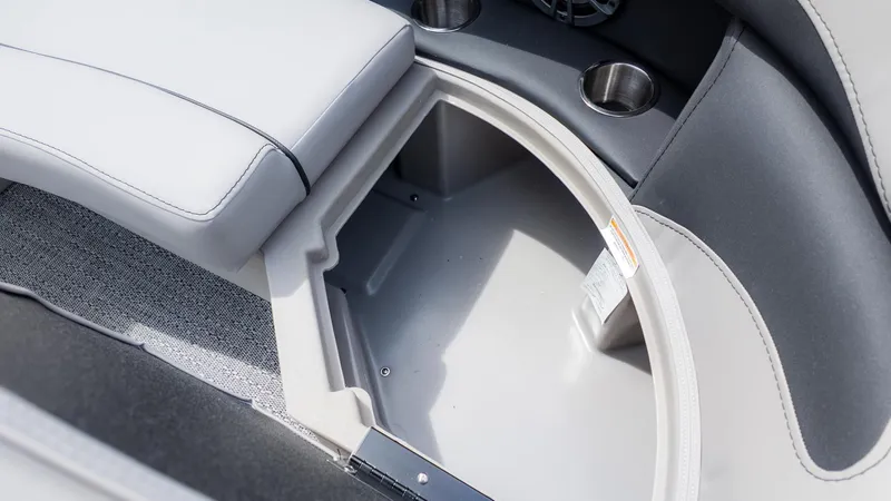 Slide: The Image of Close-up of a storage compartment in a boat with gray upholstery and cup holders. - 13